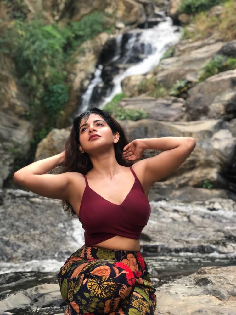 Captivating curvy beauty Actress IswaryaMenon sizzles in this latest photoshoot shot at a waterfall